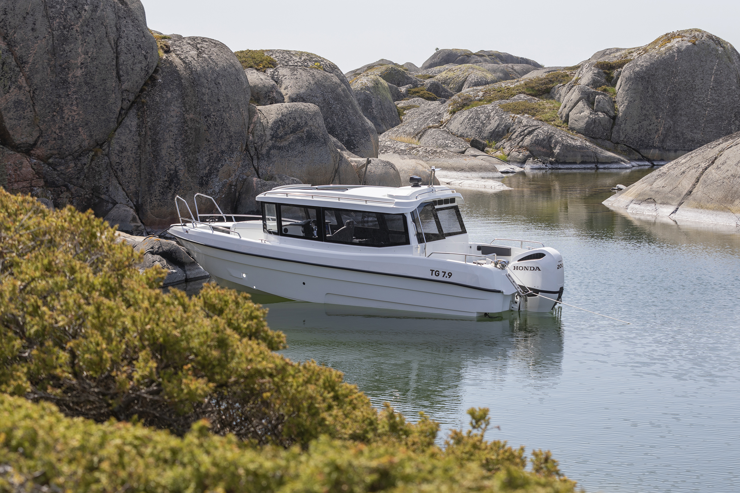 TG 7.9 cabin boat anchored amongst cliffs in the outer Finnish archipelago.